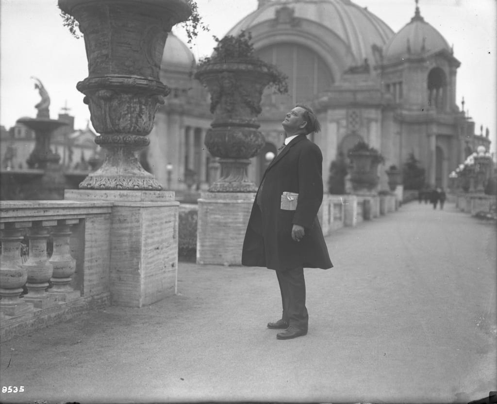 Man looking at Panama Pacific International Exposition grounds, 1915.