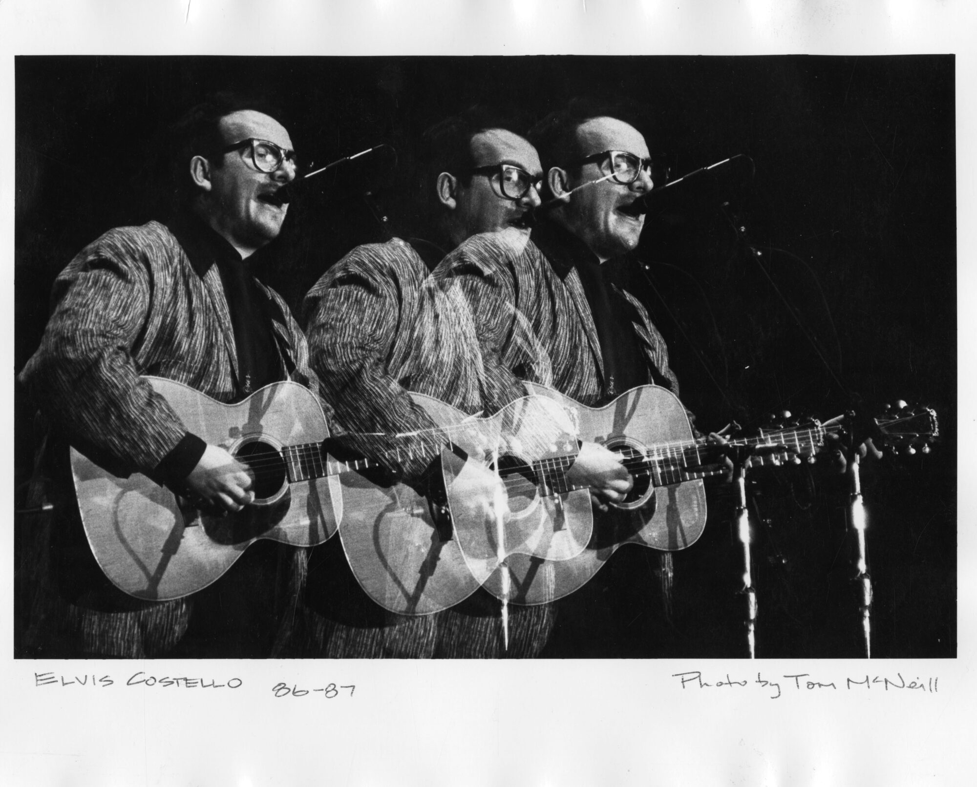 Elvis Costello playing guitar and singing