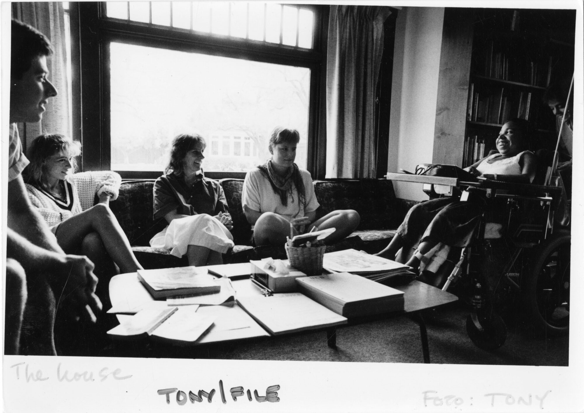 student peer counselors sitting together around a coffee table stacked with papers