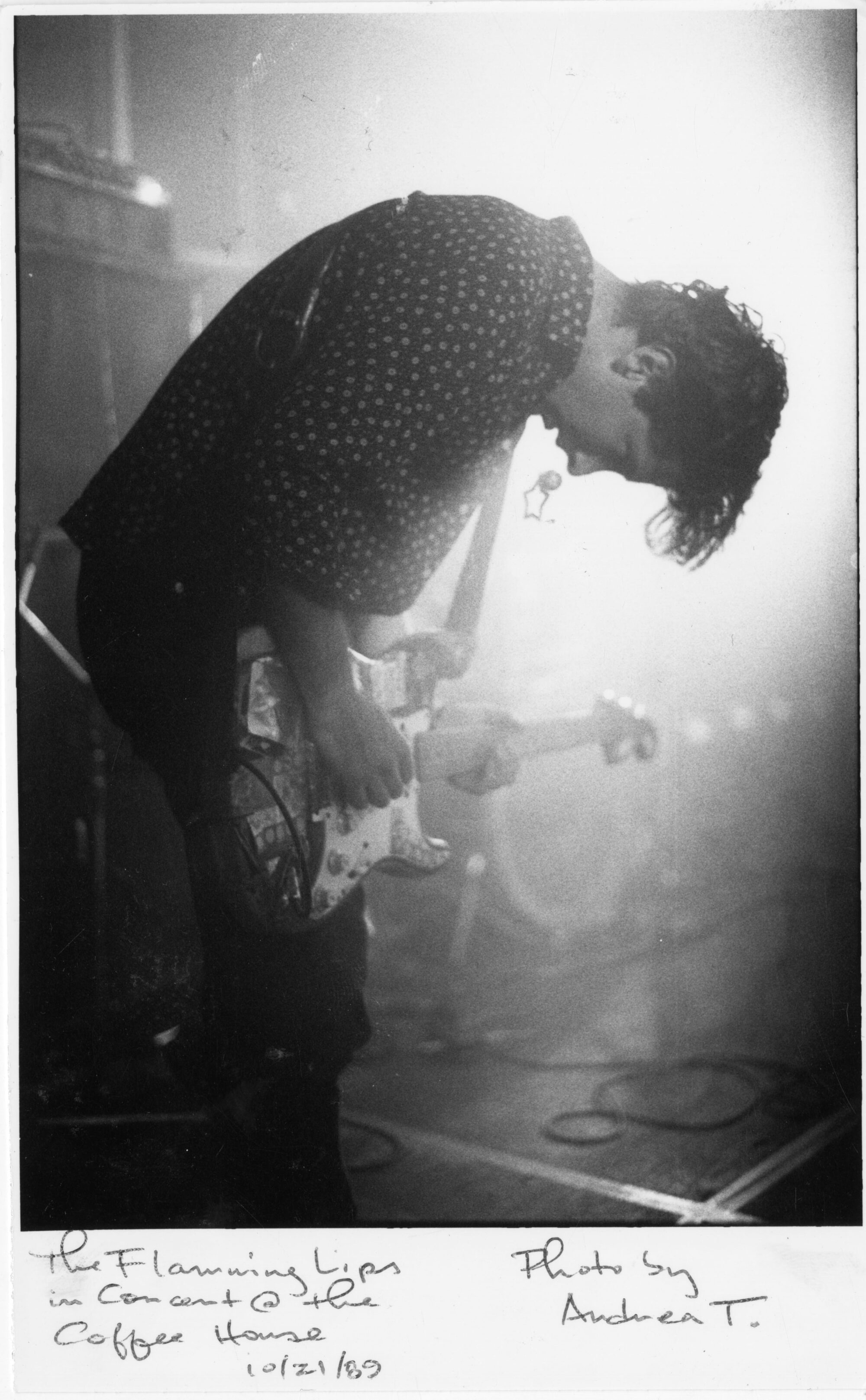 Flaming Lips musician bent over his electric guitar