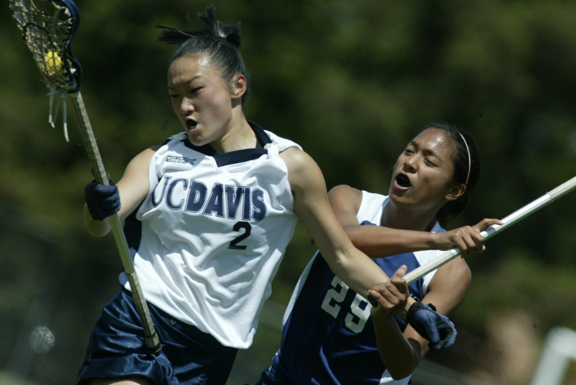 Close-up of two women playing lacrosse