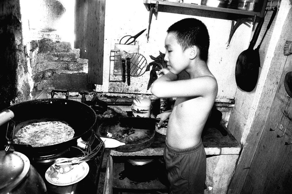 Martin Yan, 9 years old, cooking in his family's kitchen