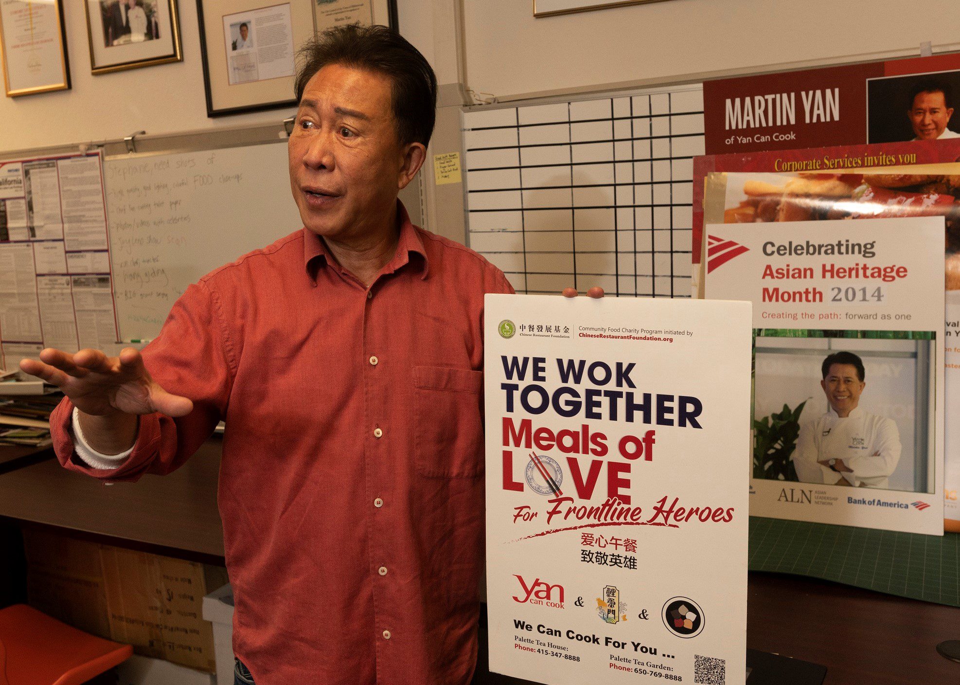Martin Yan shows a poster for Meals of Love