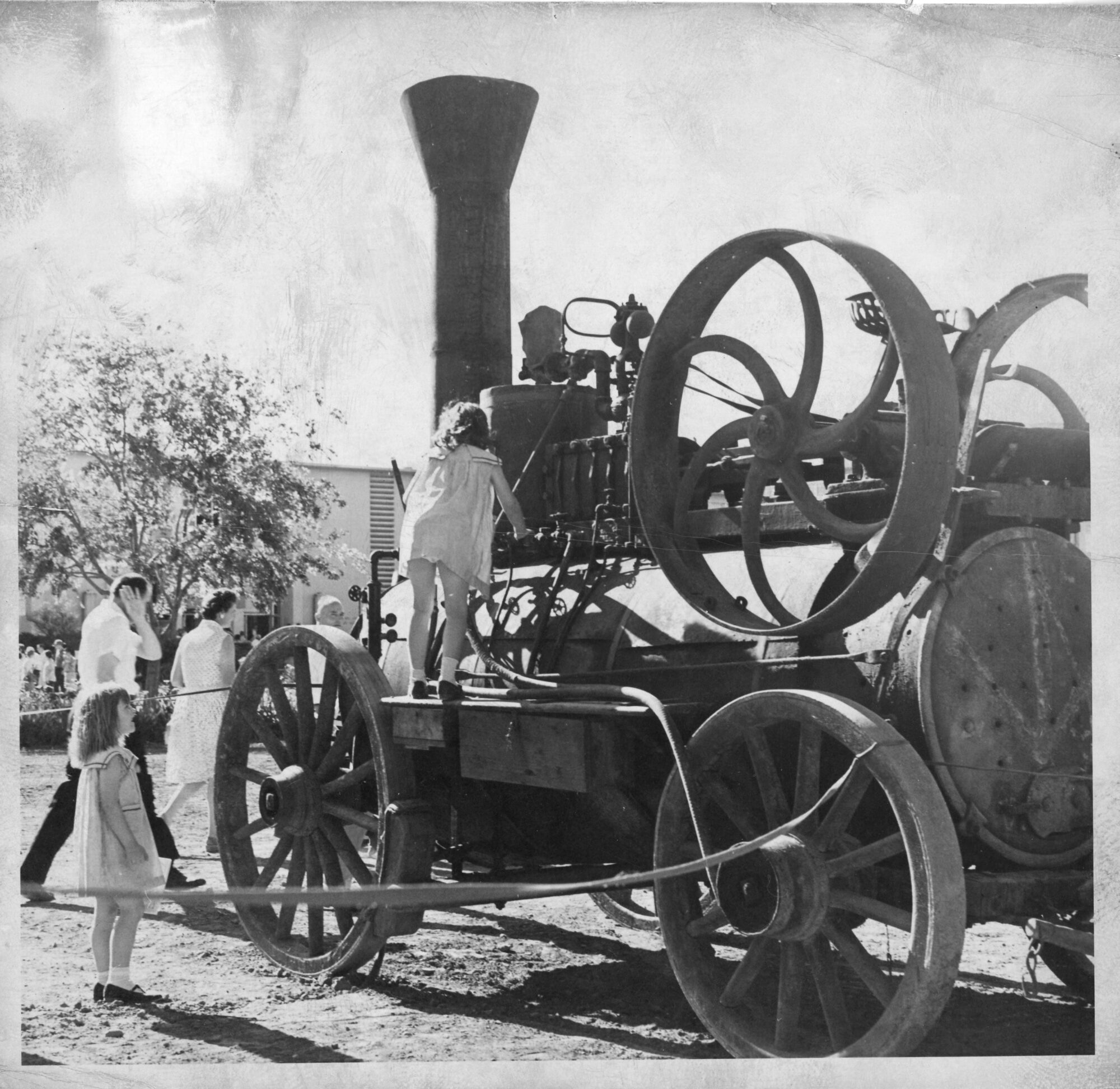 Child climbing on a large tractor