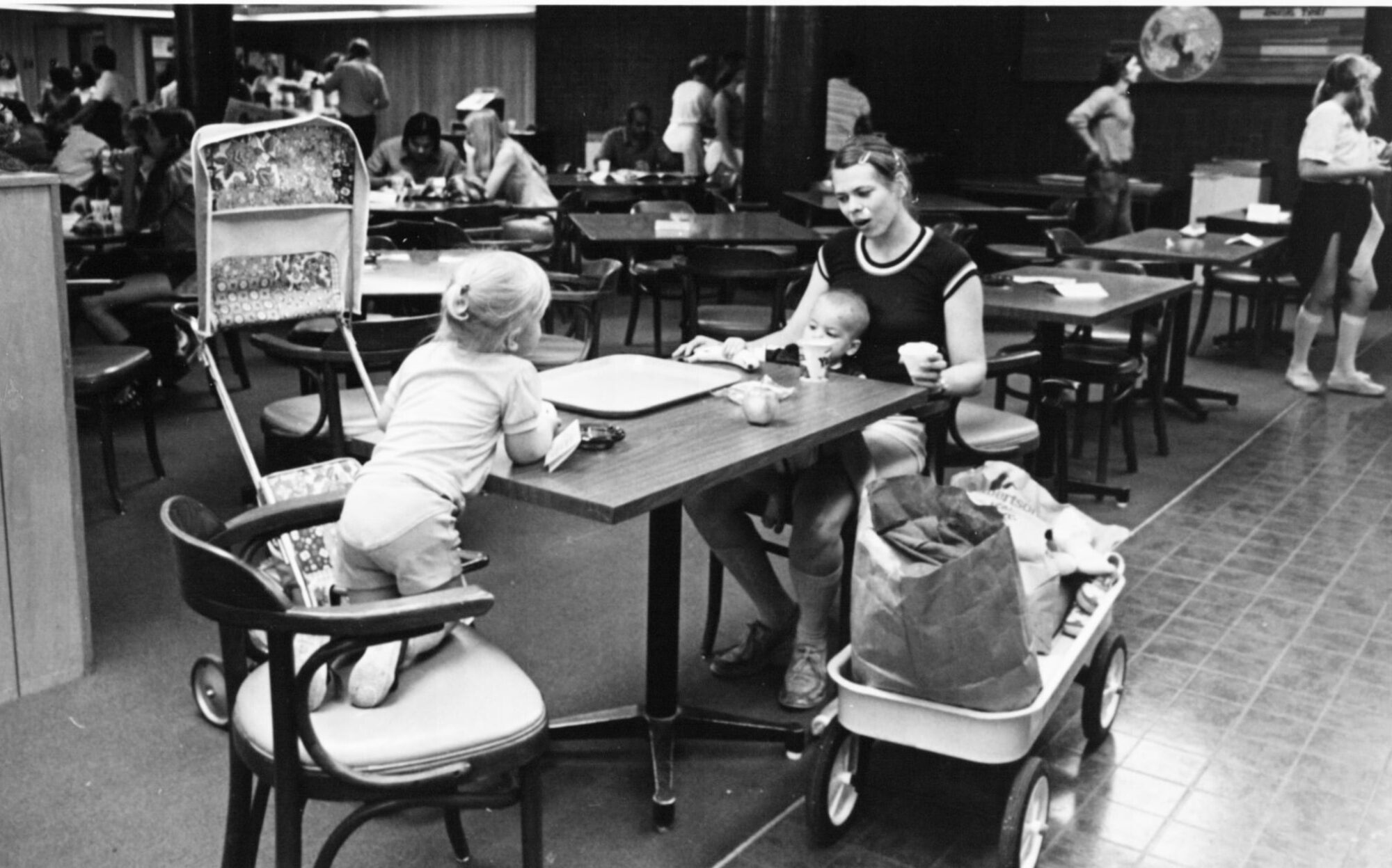 Woman and two children at a dining hall table