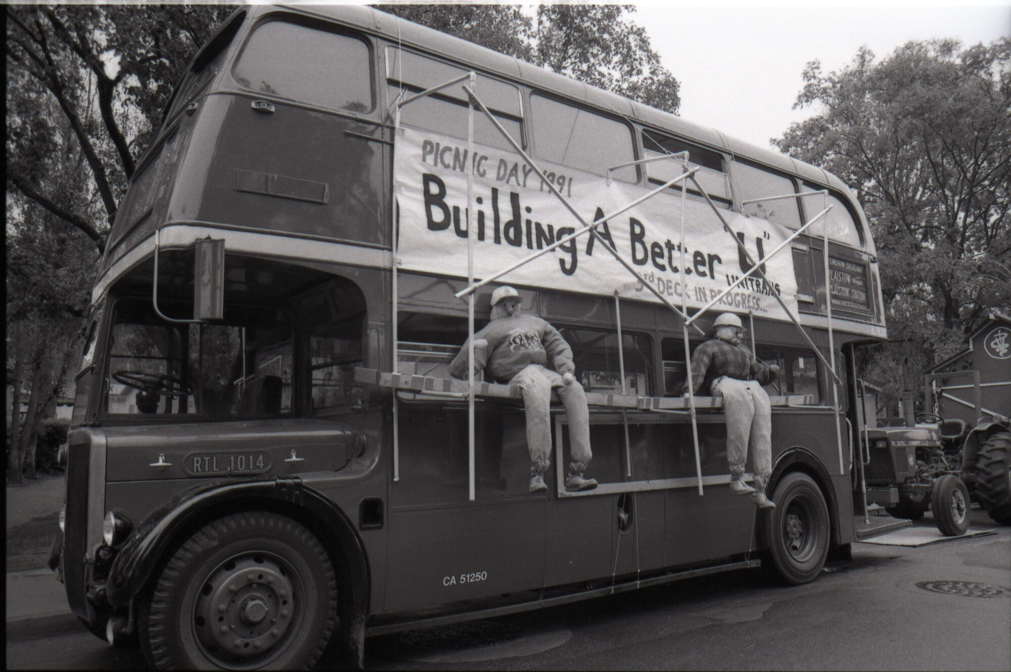 Double decker bus with banner labeled "Building a better U"