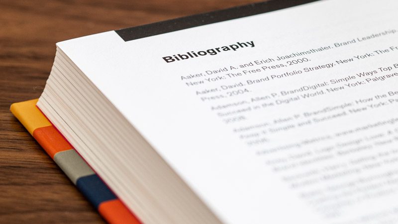 Colorful striped book opened to the bibliography page.