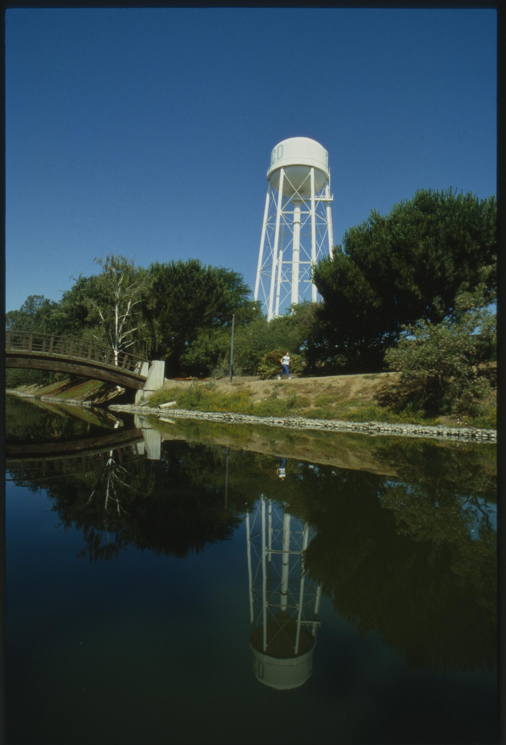 A water tower reflected in Putah Creek