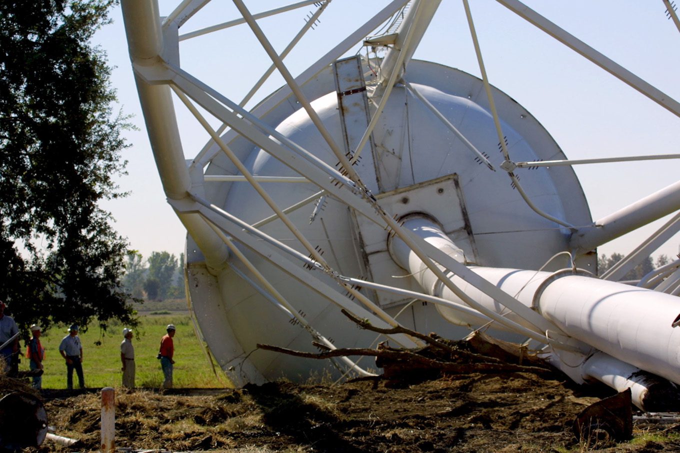 Crew examining a fallen water tower