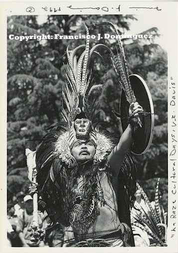An Aztec performer in cultural wear.