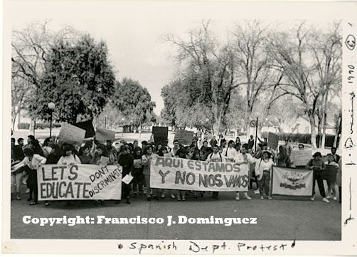 A crowd of protestors with signs marching.