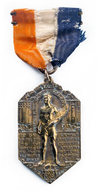 Commemorative medal with orange, white, and blue ribbon.