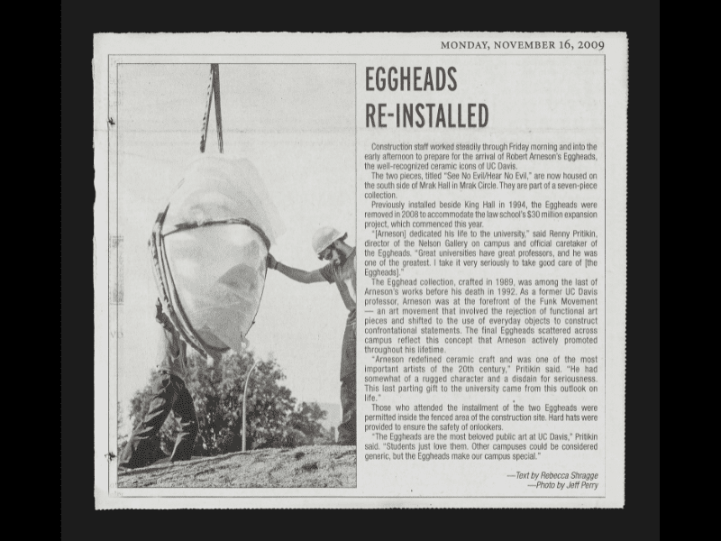 Newspaper clipping of an Egghead being lowered by a crane, with a worker on either side.