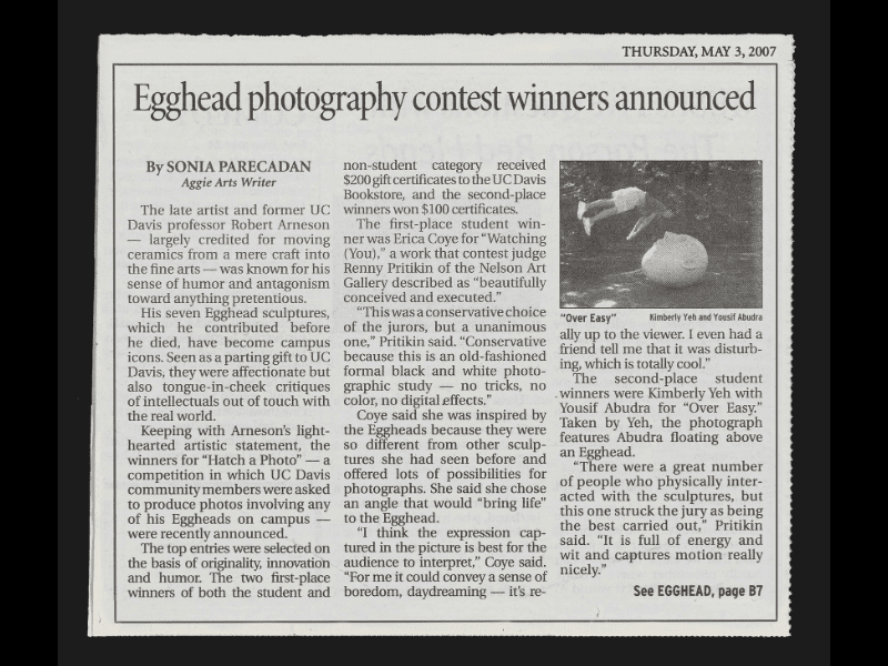 Newspaper clipping with a small inset photo of a student hovering in the air above "Stargazer", an Egghead lying on its back facing upward.