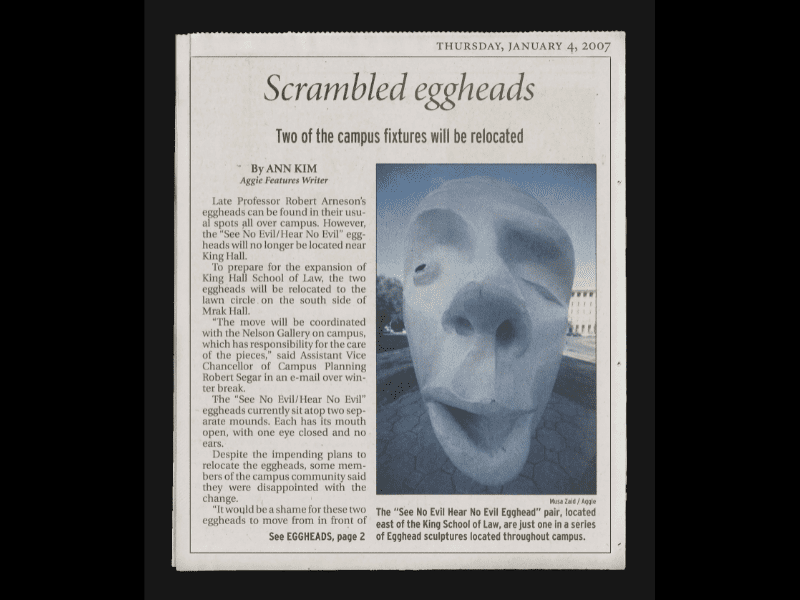 Newspaper clipping with a distorted photo of an Egghead sculpture with no ears -- the "Hear No Evil" half of the "See No Evil, Hear No Evil" pair.