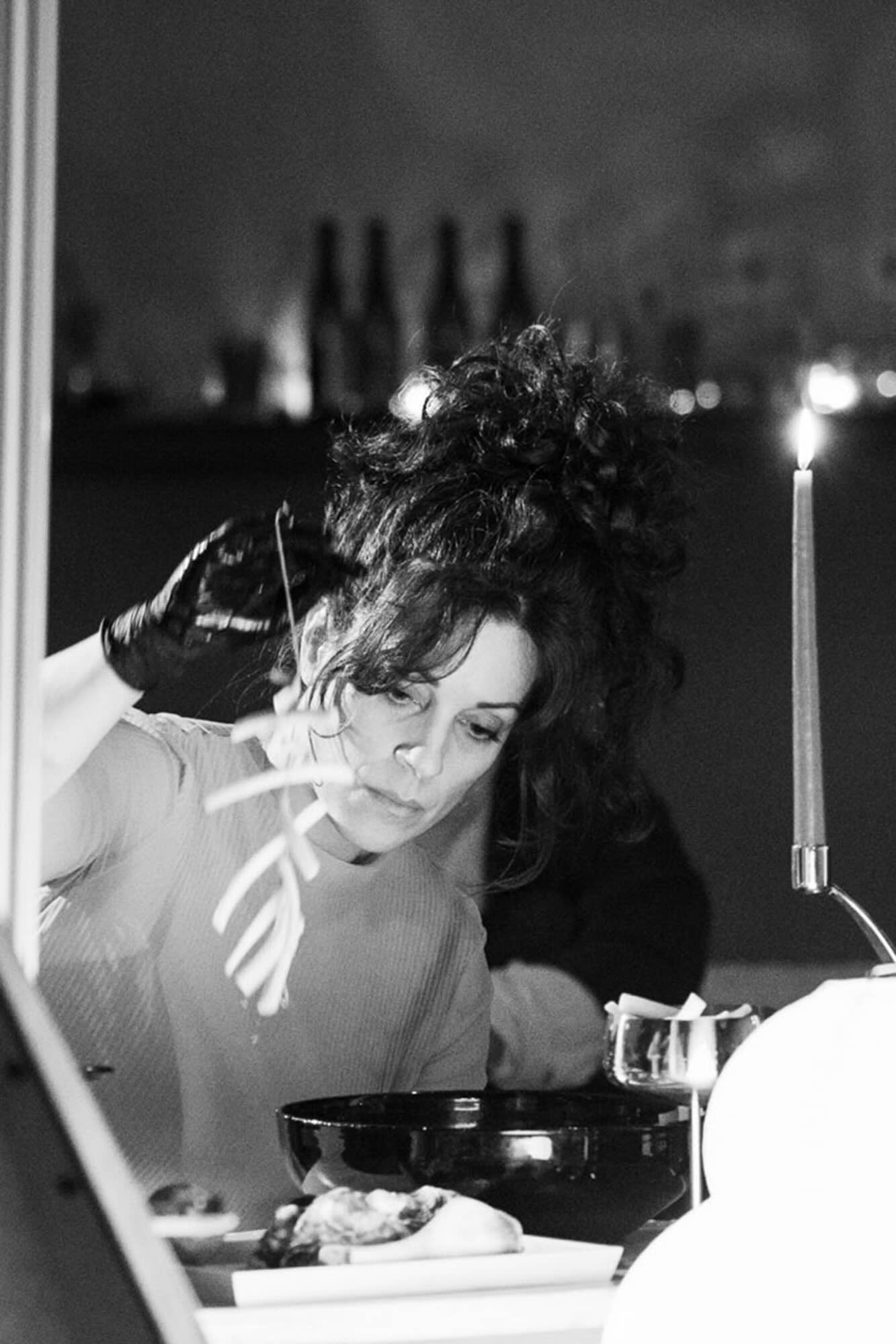 Heidi Ross, chef, lifts ingredients over her sound table