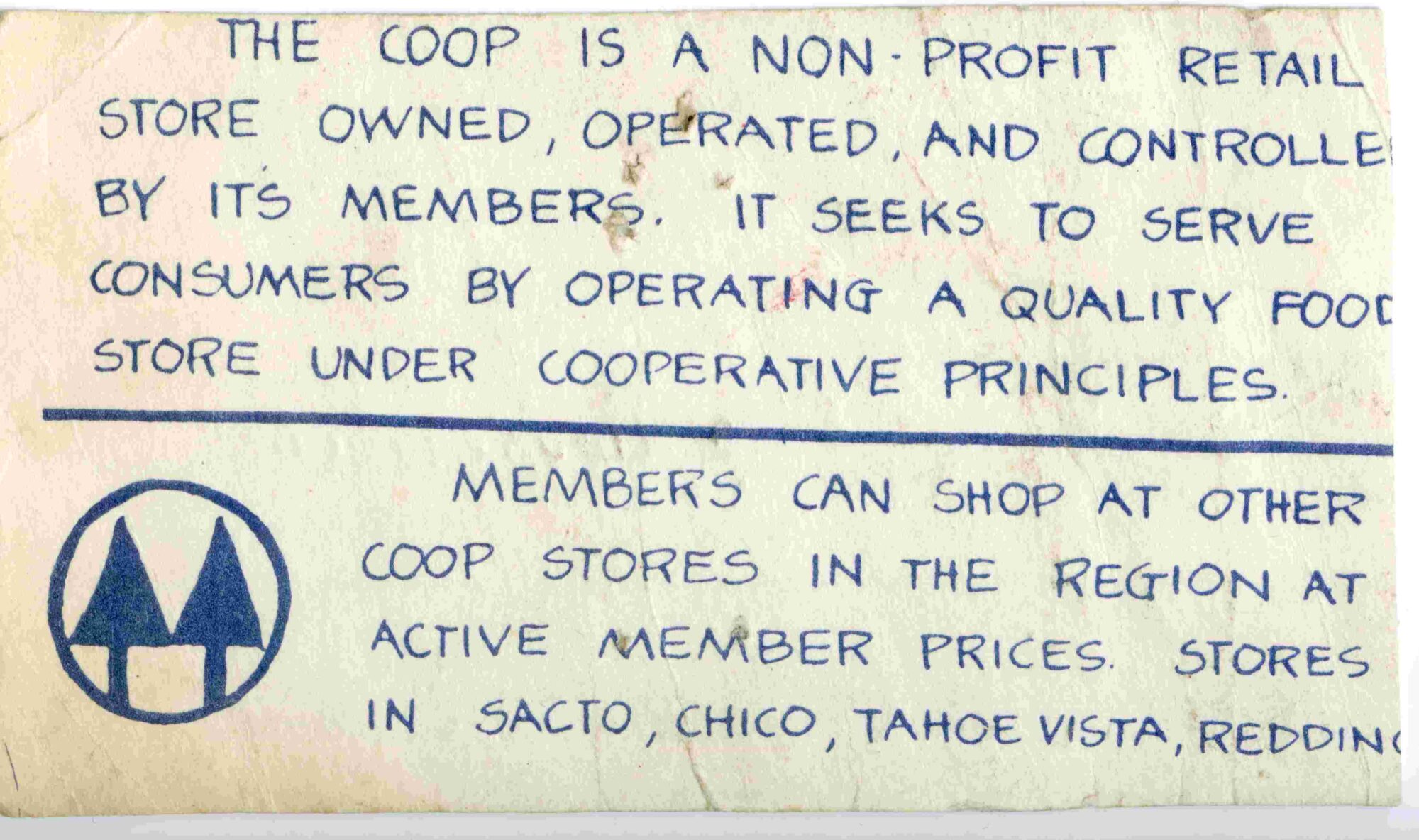 Back of Ann Evans' original membership card at the Davis Food co-op. Describes the co-op with its logo of two trees in a circle at the bottom left.