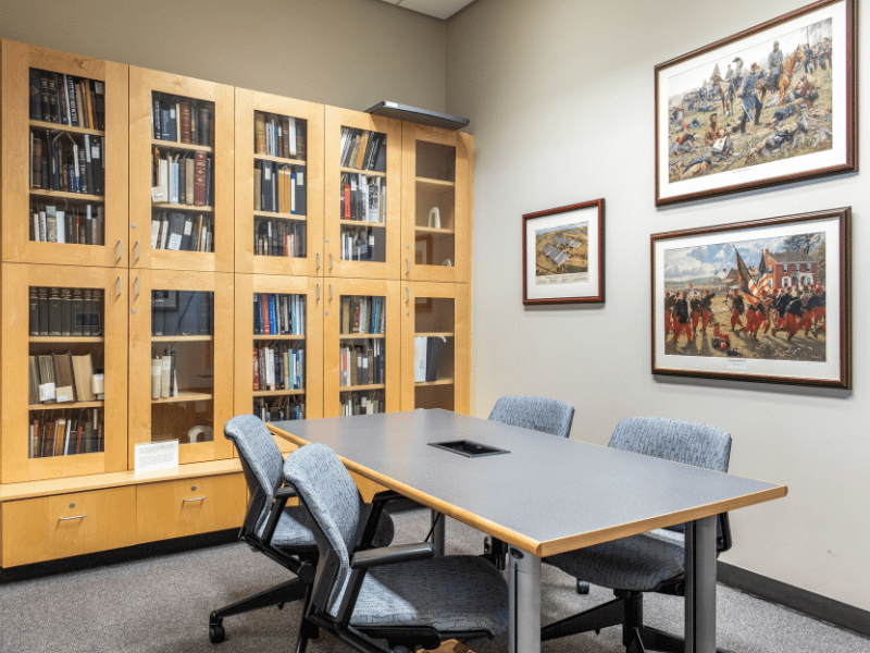BML Blaisdell Room with table and chairs, and books and paintings from Dr. Blaisdell's Civil War collection.