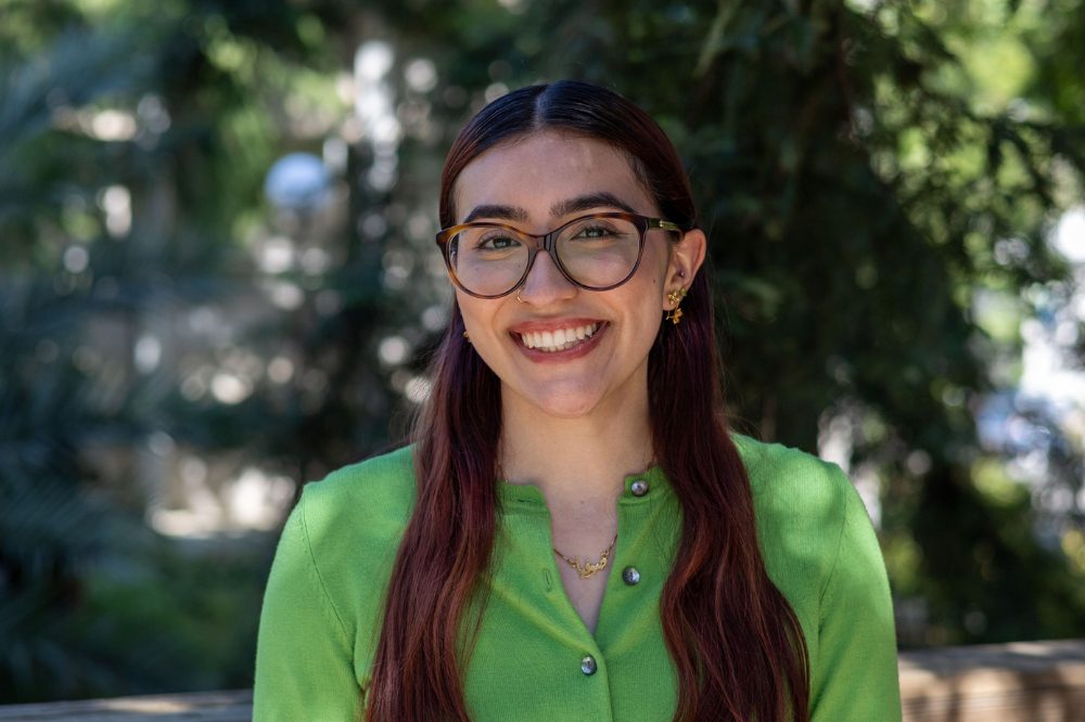 Portrait of Sofia Hosseinzadeh wearing a green shirt and glasses