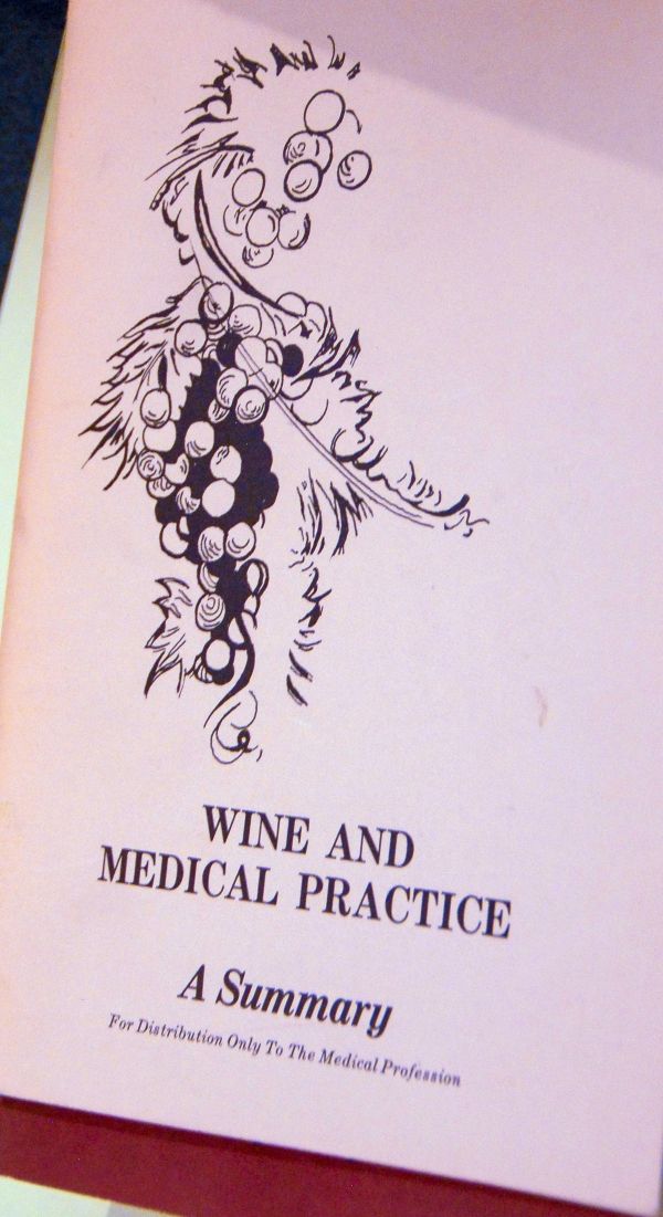 A booklet with a print of grapes entitled "Wine and Medical Practice: A Summary."