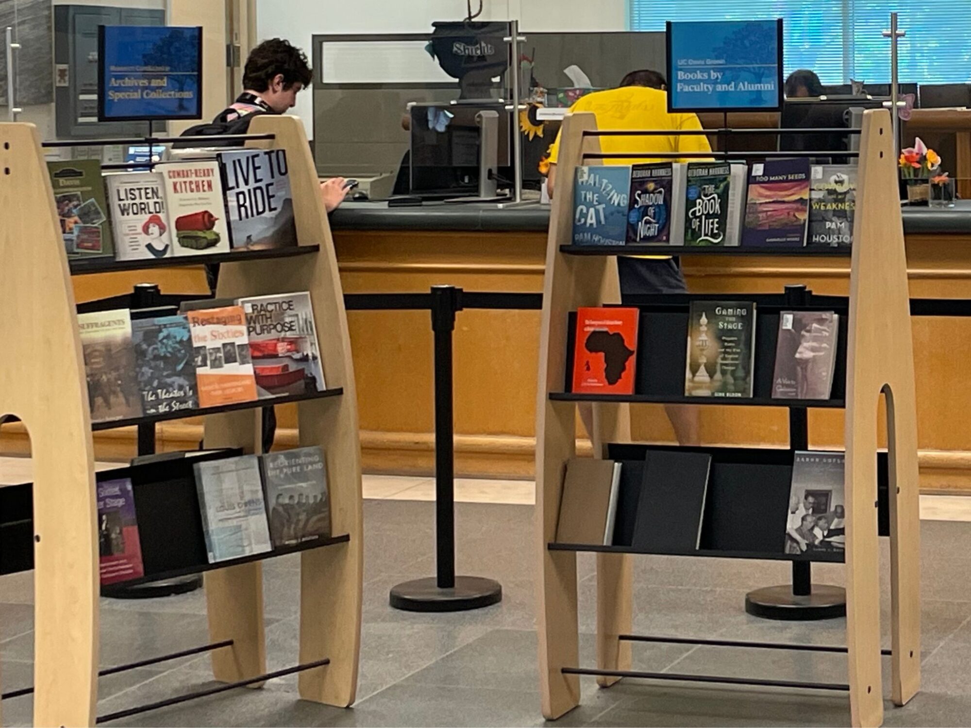 Bookshelves showcasing Research using Archives and Special Collections and Books by UC Davis Faculty and Alumni