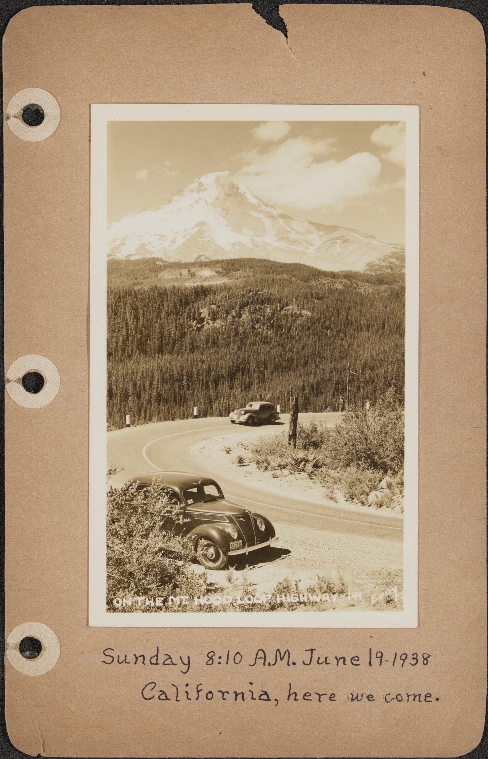 A scan of a page in the travelogue with a photograph of cars on a looped highway.