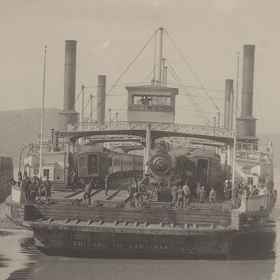 A black and white photograph of a docked boat.